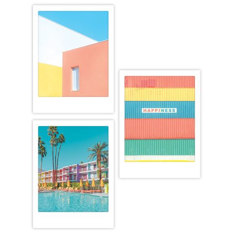 Das Colors - 3er Artposter Set von Pickmotion bietet drei lebendige, moderne Drucke - ein Gebäude, ein Hotel am Pool und eine gestreifte Wand mit dem Text "HAPPINESS". Jedes Poster leuchtet in kräftigen Farben und eignet sich perfekt für individuelle Rahmen.