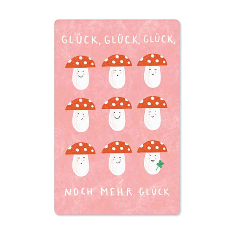 Eine rosa Pickmotion Designkarte „glück glück glück“ zeigt neun lächelnde Cartoon-Pilze mit roten Hüten und Punkten; Einer hält ein grünes Kleeblatt. Text: GLÜCK, GLÜCK, GLÜCK, NOCH MEHR GLÜCK – nachhaltige Qualität.