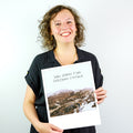 Lächelnde Frau, die ein Foto mit der Aufschrift "Wenn nichts falsch ist, ist alles möglich" hält.